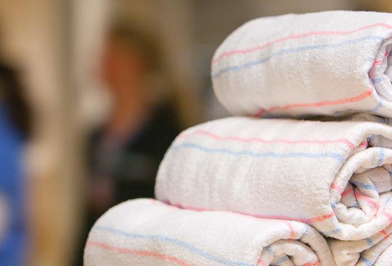 close-up of rolled pastel-striped baby blankets in a hospital 