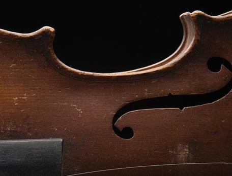 partial view of a violin on its side