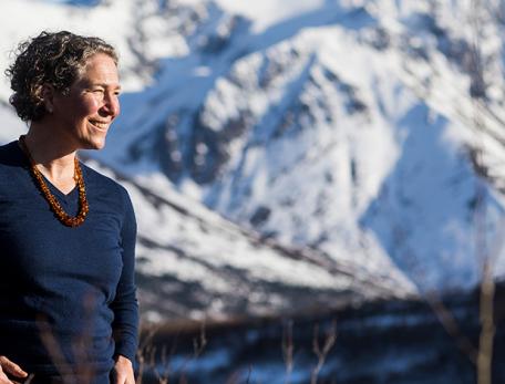 Marna Schwartz standing outside, mountains in the distance 