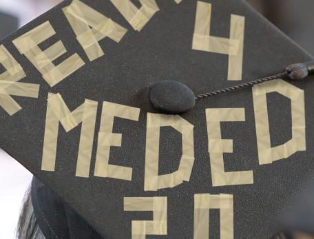 Top view of a morterboard with masking tape forming words: ready for med ed