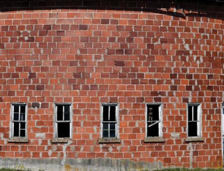 a round red-brick barn, roof not visible