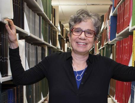 Long shot of Deborah Zarin in aisle between book shelves