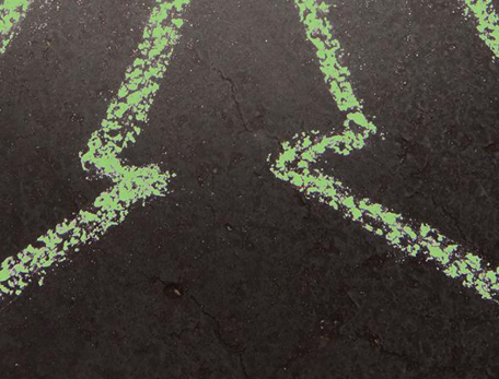 chalked green arrows pointing in opposite directions on black background