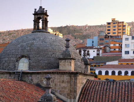 The bell tower of the Iglesia de San Francisco in La Paz faces an array of contemporary housing, old and new coexisting in a vibrant city that beckons those seeking change.