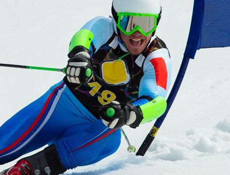 man in bright colors skiing