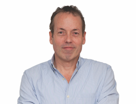 a man standing with his arms folded against a white background
