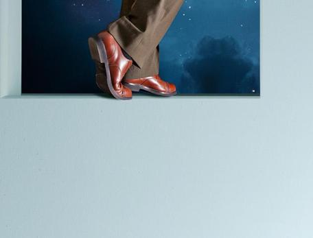 close up of feet in brown dress shoes exiting through a door