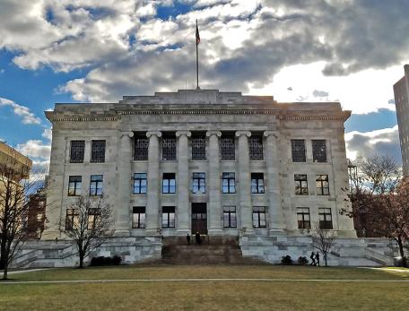 gordon hall with a cloudy and sunny sky behind it