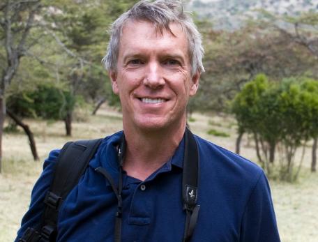 mark stoeckle standing in a grassy area with small trees