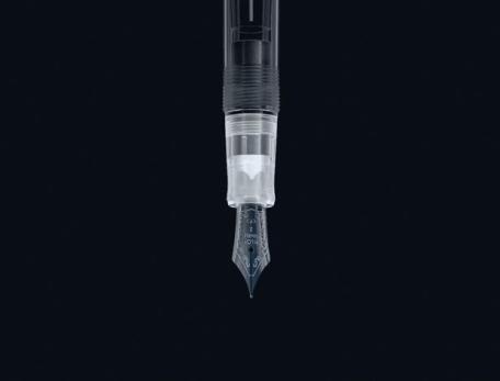 tip of a fountain pen against a black background