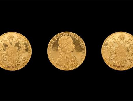 three golden coins on a black background