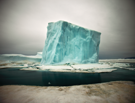 Lone iceberg eerily lit with blueish cast
