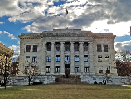 gordon hall with a cloudy and sunny sky behind it