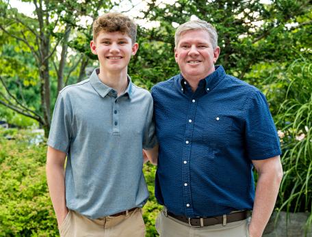 Photo showing a closeup of Brendon Paradis and his son Keegan standing next to each other
