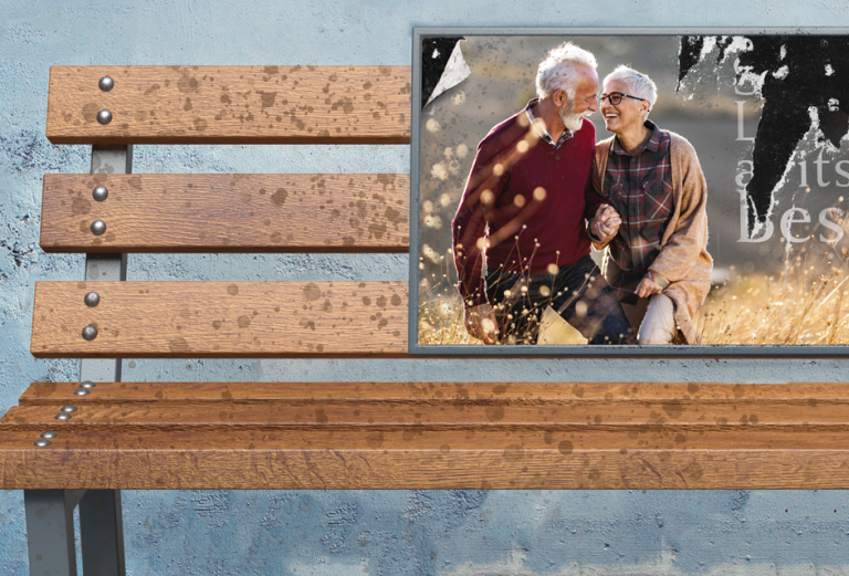 detail of image showing an empty park bench that has a weathered ad for assisted or independent living for older adults