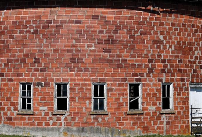 a round red-brick barn, roof not visible