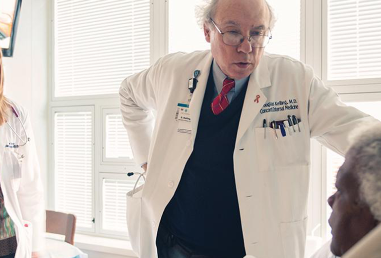 Douglas Kelling with young physician at bedside