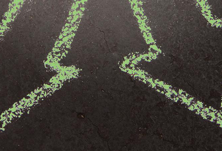 chalked green arrows pointing in opposite directions on black background