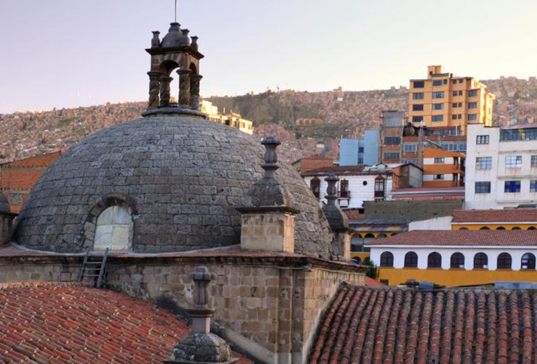 The bell tower of the Iglesia de San Francisco in La Paz faces an array of contemporary housing, old and new coexisting in a vibrant city that beckons those seeking change.