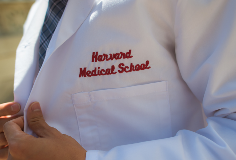 a person wearing a harvard medical school labcoat