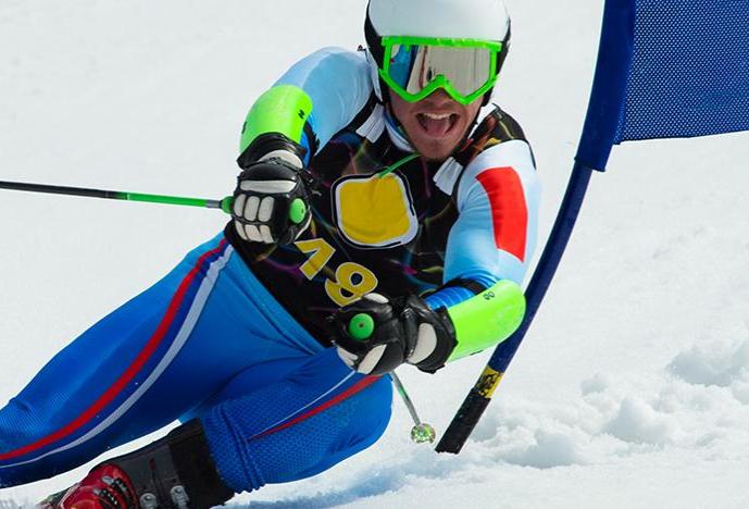 man in bright colors skiing