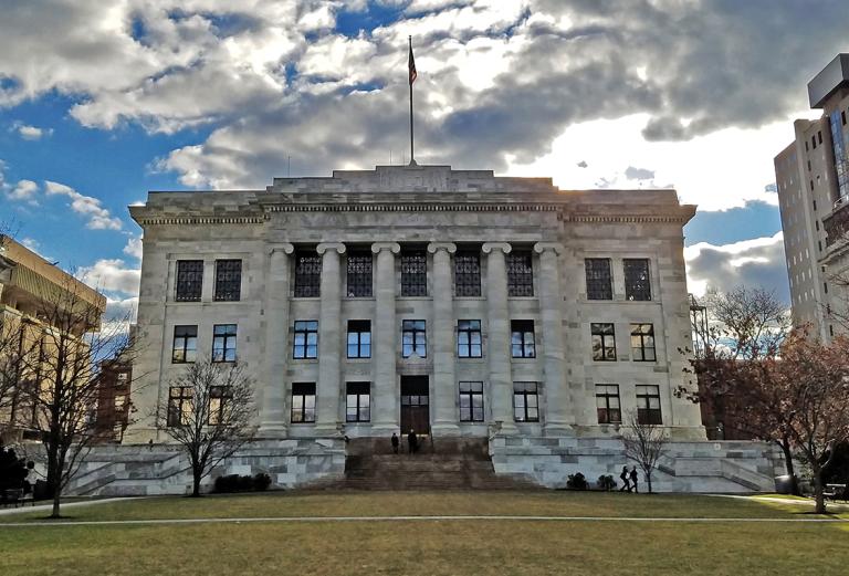 gordon hall with a cloudy and sunny sky behind it