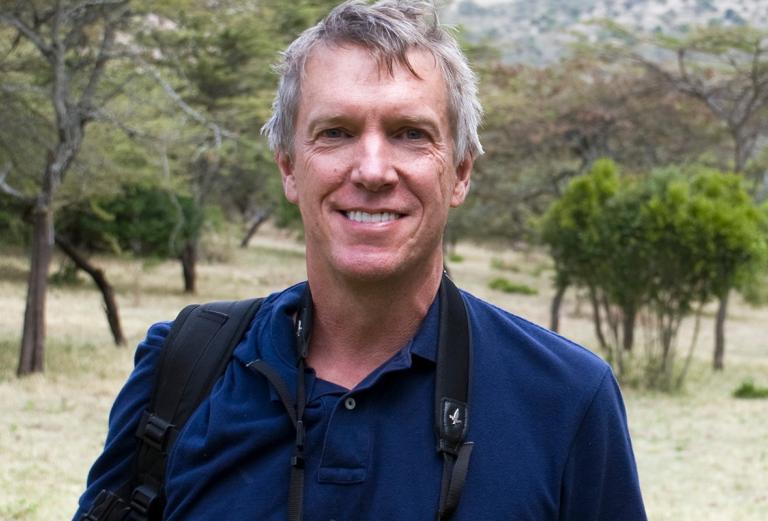 mark stoeckle standing in a grassy area with small trees