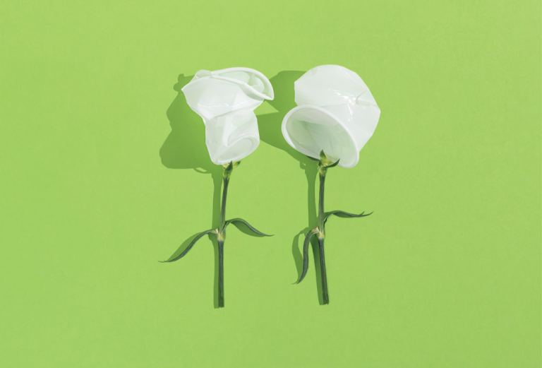 two plant stems with crushed white plastic cups as blossoms