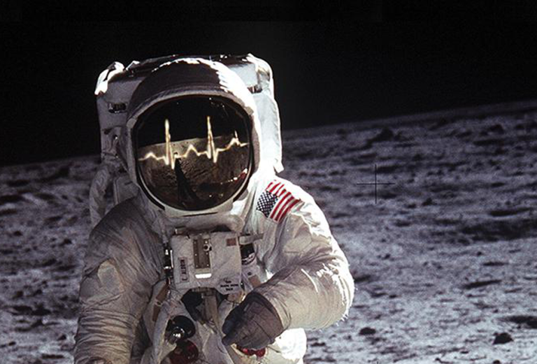 Image of astronaut walking on moon with EKG reading across glass face shield