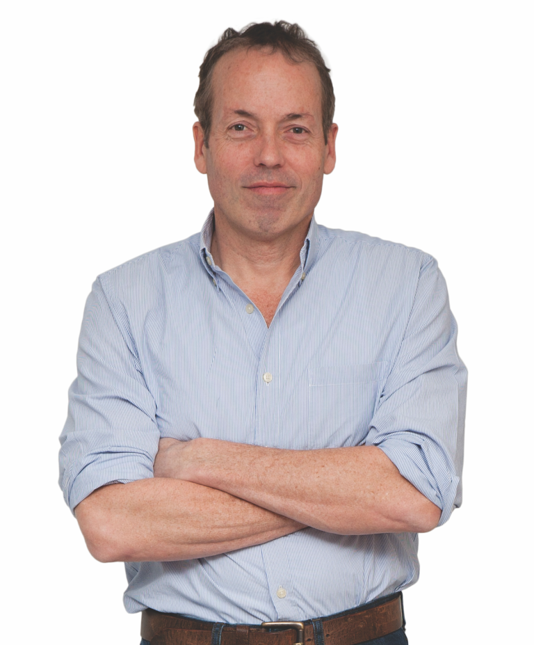 a man standing with his arms folded against a white background