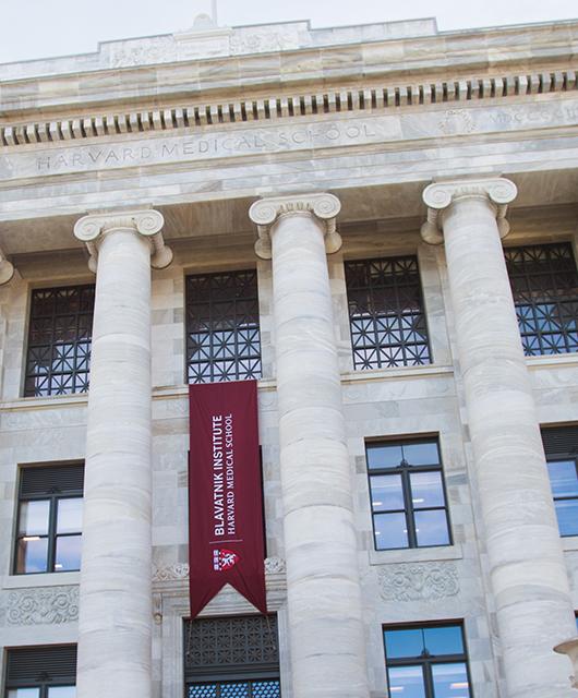 Perspective of the front of Gordon Hall with red banner