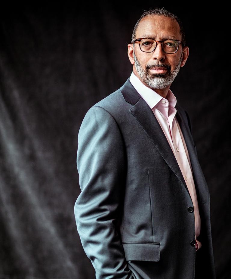 Levi Garraway standing against a gray background.