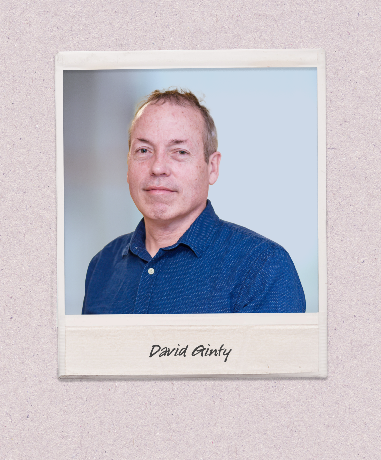 A headshot of David Ginty appears on a polaroid-style photo against a beige background.