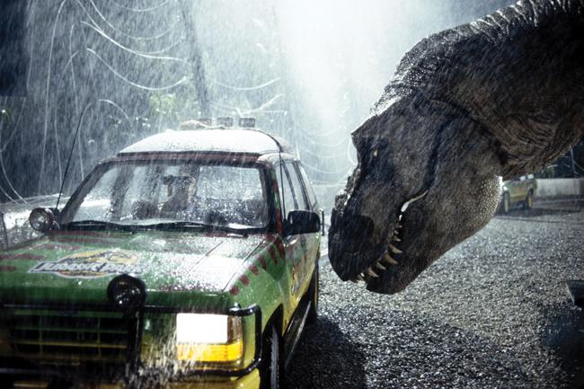 still from the movie Jurassic Parl showing dinosaur looking in the window of a car