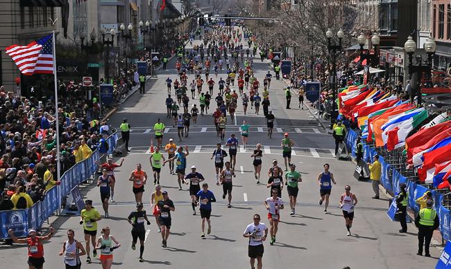 Runners crossing the finish line, viewed from above