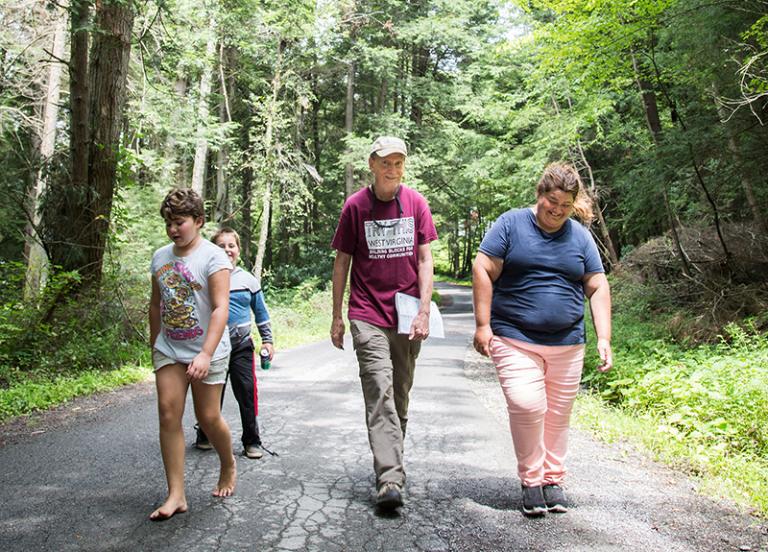 Daniel Doyle walking with neighbor Sandra Keeney and two of her children, Morgan and Aaden