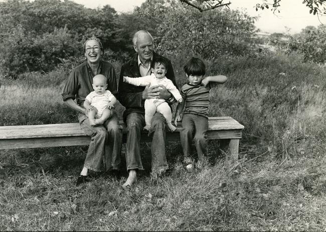 black and white photo of grandparents with three grandchildren, two on laps