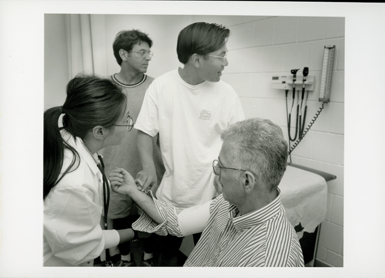 The two young men in this 1998 photo are being instructed on how to obtain a person’s pulse rate and blood pressure.