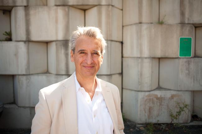 claudio toppelberg standing in front of a stone wall