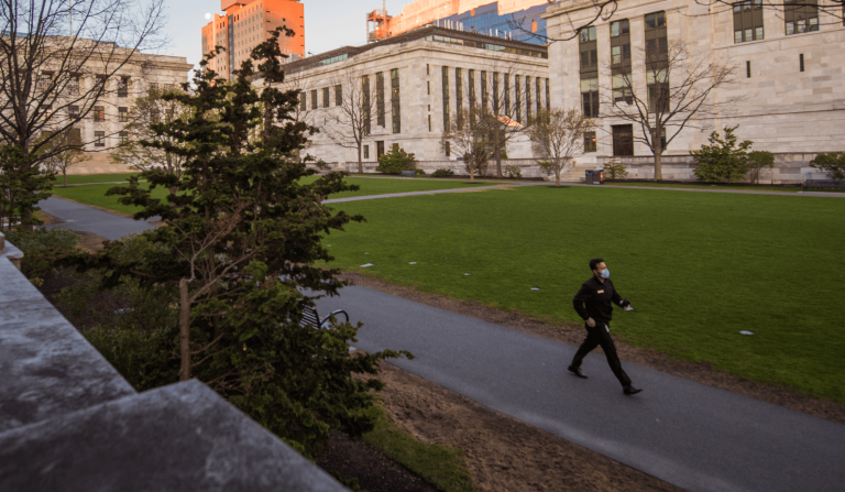 Person walking on HMS campus during Covid-19