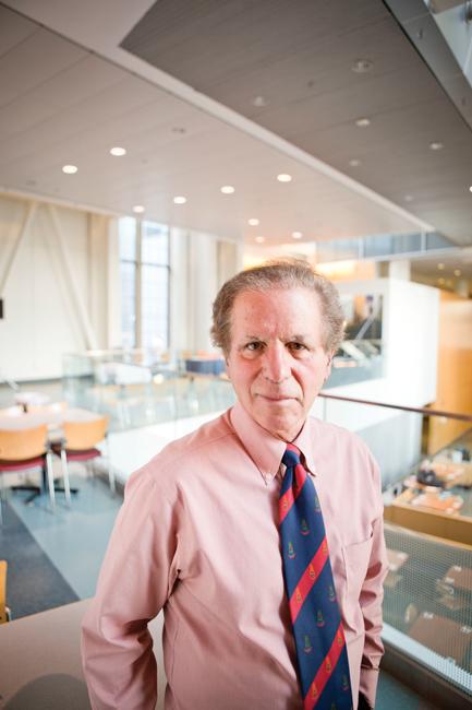 man in a red shirt and stripped tie in a conference room