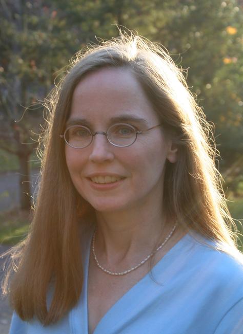 karin stromswold standing in front of a tree