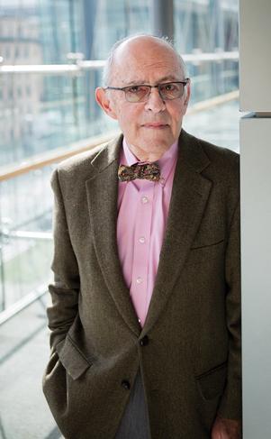 Mitchell Rabkin wearing a bow tie and standing in front of a glass wall