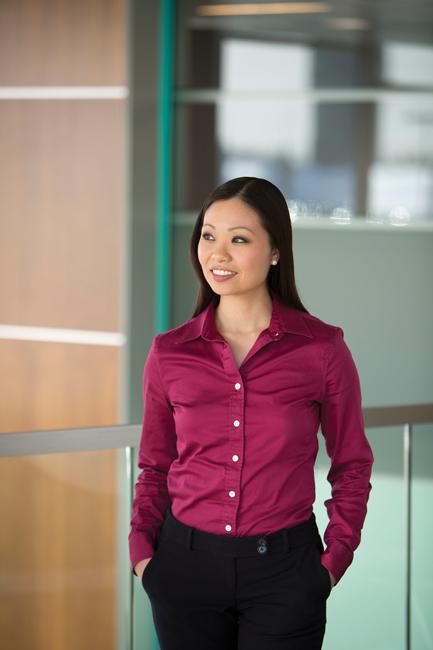woman in purple button up shirt standing in office building