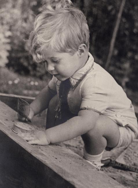 small blonde boy playing outside