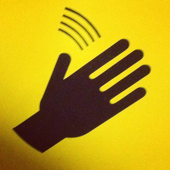 artistic rendering of a black hand on a yellow background