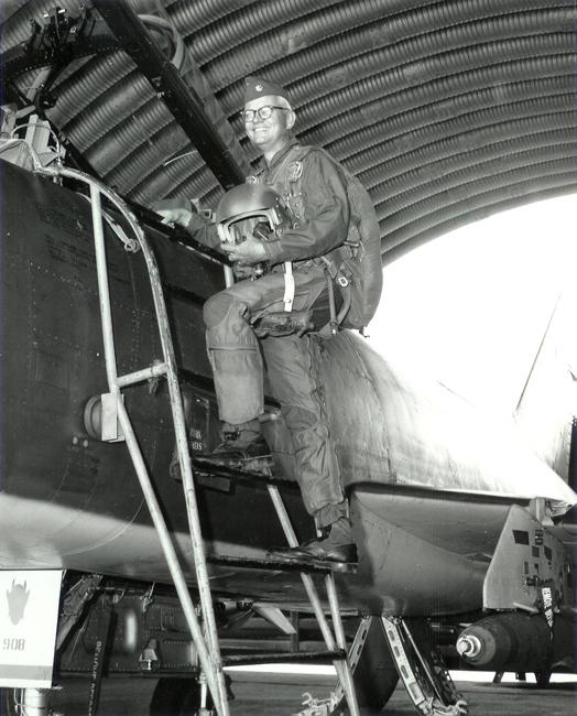 Image of Royce Moser mounting an aircraft.