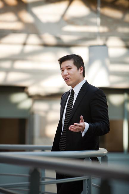 man in black suit talking