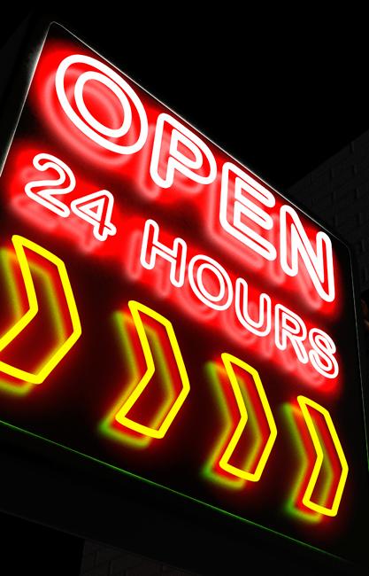 neon sign at night saying open 24 hours 