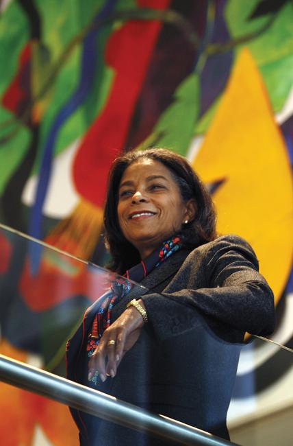 woman leaning on rail and smiling at camera